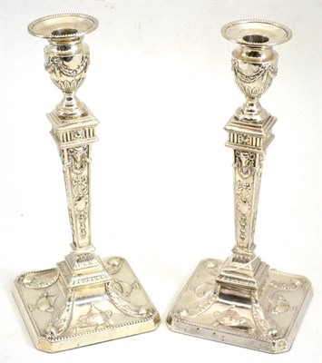 Lot 413 - A matched pair of Neo Classical style silver candlesticks decorated with typical ram's heads...