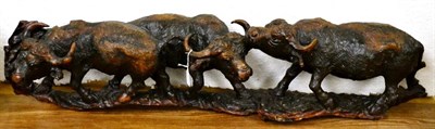 Lot 422 - A carved wood group of three buffaloes