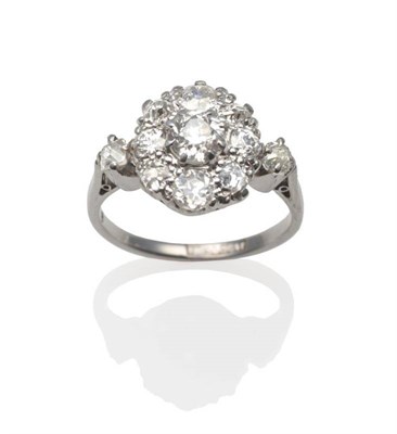 Lot 202 - A Diamond Cluster Ring, an old cut diamond within a border of smaller old cut diamonds in white...