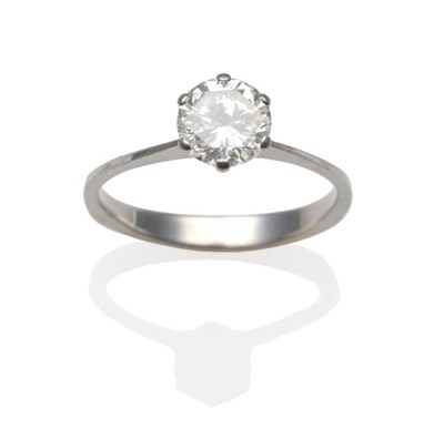 Lot 203 - A Diamond Solitaire Ring, a round brilliant cut diamond in a white claw setting, to knife edge...