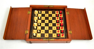 Lot 491 - Early 20th century travelling chess set in mahogany with bone pieces