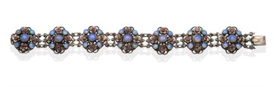 Lot 206 - An Arts & Crafts Opal and Garnet Bracelet, by Zoltan White & Co., formed of seven links each...