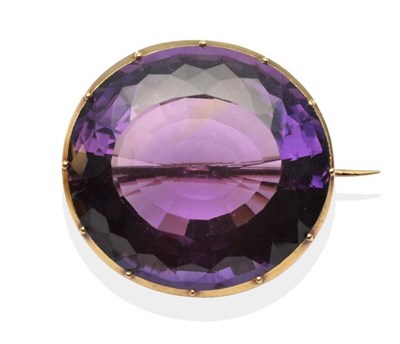 Lot 208 - A Large Amethyst Brooch, an oval cut amethyst in a yellow collet and claw setting, measures...