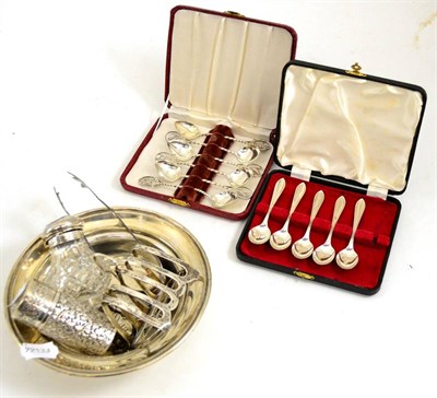 Lot 560 - A collection of silver and white metal including a toast rack, teaspoons, inkwell, etc