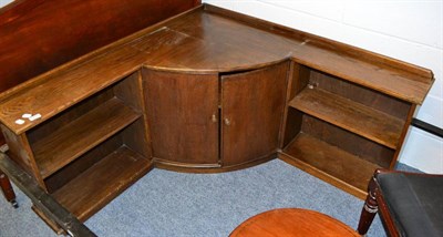 Lot 1010 - An oak shelf and cupboard corner unit