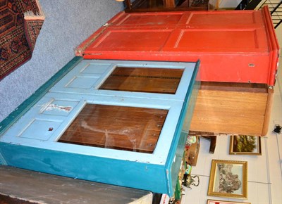 Lot 1017 - Red painted two door kitchen cupboard and a blue painted glazed bookcase