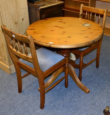 Lot 1022 - Modern circular pine kitchen table and two spindle back chairs