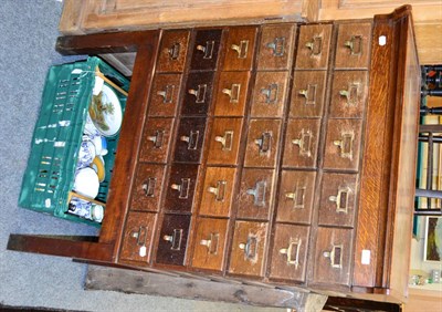 Lot 1028 - An oak chest of multi drawers on a later stand