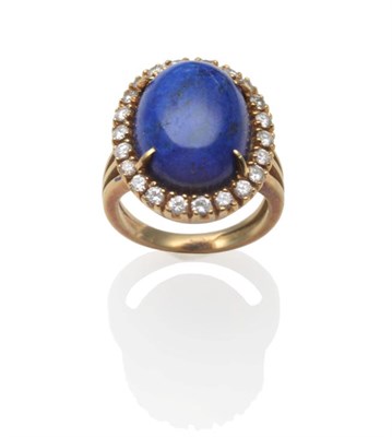 Lot 223 - A Lapis Lazuli and Diamond Cluster Ring, an oval cabochon lapis lazuli within a border of round...