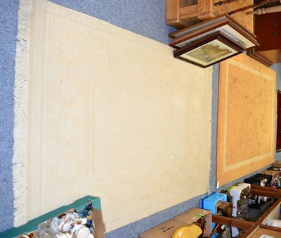 Lot 1051 - Small modern brown wool carpet and a cream rug