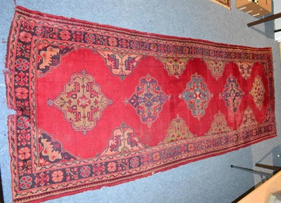 Lot 1095 - Ushak carpet, Central Anatolia, the tomato red field with four medallions enclosed by...