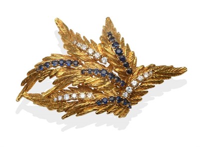 Lot 235 - An 18 Carat Gold Diamond and Sapphire Spray Brooch, formed of seven leaves each set with a band...