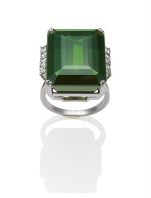 Lot 241 - A Green Tourmaline and Diamond Ring, an emerald-cut green tourmaline in a white claw setting...