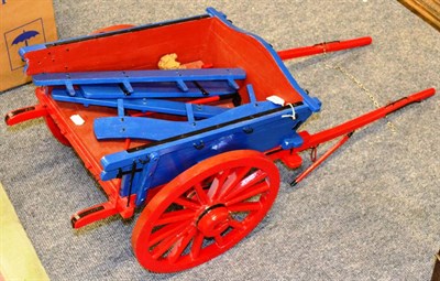 Lot 1194 - A small blue and red painted cart