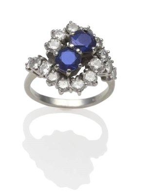Lot 246 - An 18 Carat White Gold Sapphire and Diamond Twist Ring, two round cut sapphires in claw settings to