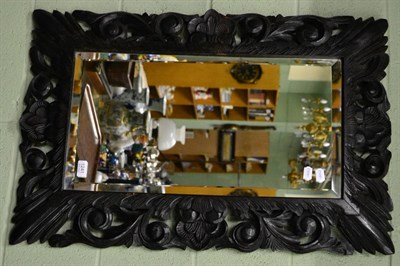 Lot 1241 - Ebonised carved oak mirror, labelled 'Charles Lowe Furnishers Loughborough"