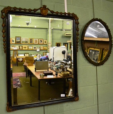 Lot 1270 - An ebonised and gilt decorated rectangular wall mirror and an oval example