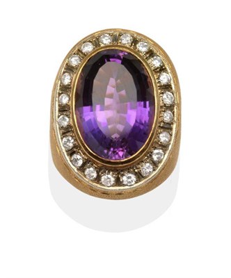 Lot 262 - An Amethyst and Diamond Cluster Ring, an oval cut amethyst in a yellow rubbed over setting and...