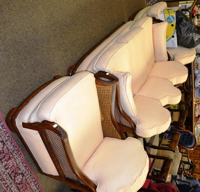 Lot 1365 - A walnut framed three piece bergere suite with cream upholstery