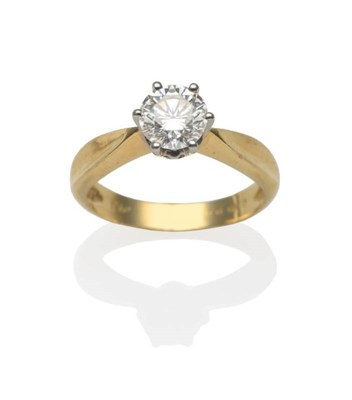 Lot 265 - A Diamond Solitaire Ring, a round brilliant cut diamond in a white six claw setting, to yellow...