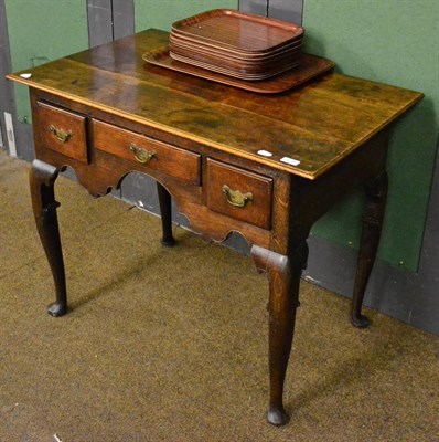 Lot 1439 - An 18th century oak lowboy