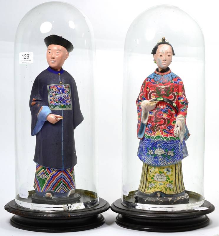 Lot 129 - A pair of polychrome decorated Chinese figures, with nodding heads dresses in court robes, on...