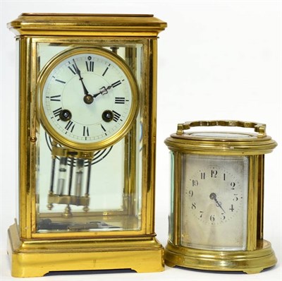 Lot 130 - A gilt brass four glass mantel clock; together with an oval gilt brass carriage clock (one side...