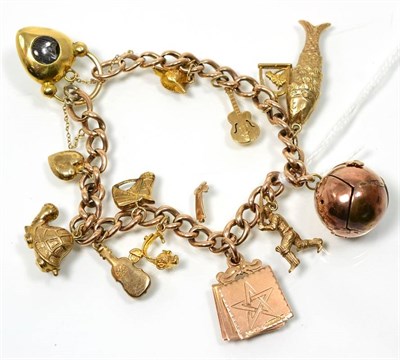 Lot 155 - A curb link charm bracelet, suspending twelve various 9 carat gold and other charms, including...