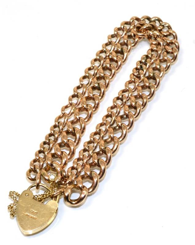Lot 158 - A 9 carat gold double graduated curb link bracelet, with a 9 carat gold padlock clasp, length 20cm