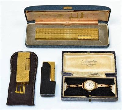 Lot 175 - A Dunhill gold plated table lighter, of elongated form, cased; with two Dunhill gold plated...