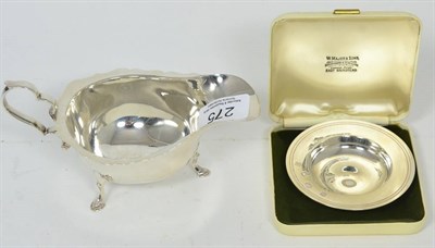 Lot 275 - A Georgian style silver sauce boat, marks rubbed; and a small silver Armada dish, Comyns,...