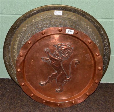 Lot 293 - An Arts & Crafts copper charger decorated with a lion; and a brass decorative tray (2)