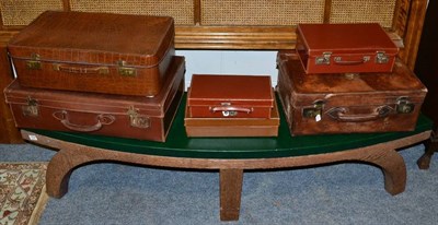 Lot 1052 - Japanese oak curved hall bench; and six various vintage suitcases