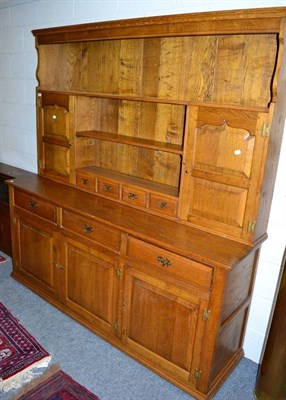 Lot 1065 - An oak dresser with plate rack back