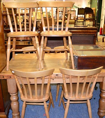 Lot 1073 - A pine table and a set of six chairs