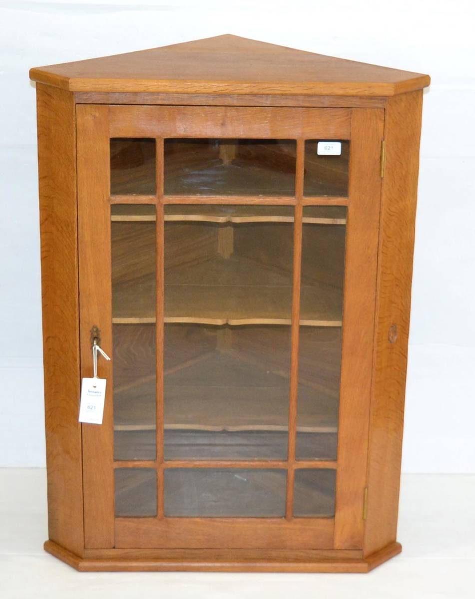 Lot 621 - An Alan Grainger Acorn Industries Glazed Oak Hanging Corner Cupboard, with three fixed shelves,...