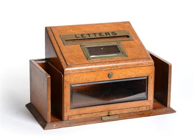 Lot 197 - A Victorian Oak and Brass Mounted Table Top Letter Box with two glazed windows and pen slide....