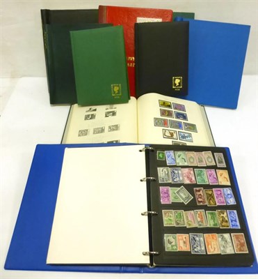 Lot 78 - A Miscellaneous Assortment of world issues in a clear plastic container. Includes a blue binder...