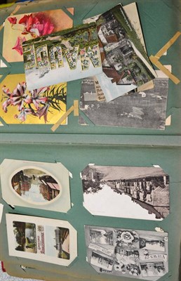 Lot 451 - A Large Red Distressed Album housing over four hundred postcards. Includes topographical, comic...