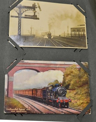 Lot 549 - Trains. A distressed album, part filled with real photographic and coloured cards (45)....