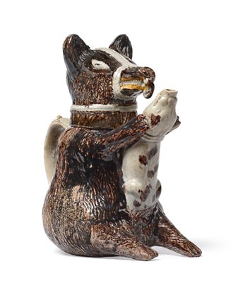 Lot 29 - A Pratt-type Pottery Bear Jug and Cover, circa 1800, naturalistically modelled holding a dog in its