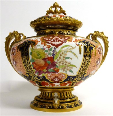 Lot 56 - A Royal Crown Derby Porcelain Boat Shaped Twin-Handled Vase and Cover, 1903, decorated in the Imari