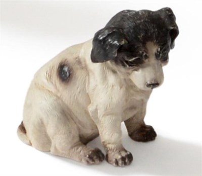 Lot 70 - An Austrian Painted Terracotta Figure of a Puppy, circa 1900, seated, with black and white...