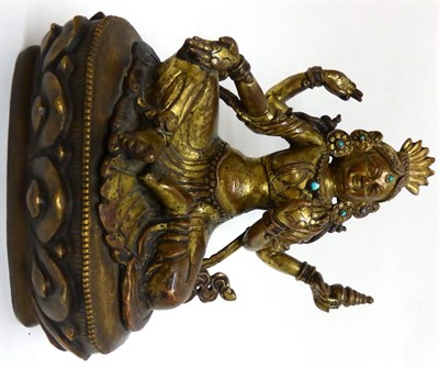 Lot 112 - A Tibetan Gilt Copper Alloy Figure of Avalokiteshvara, 15th century, sitting on a lotus leaf...