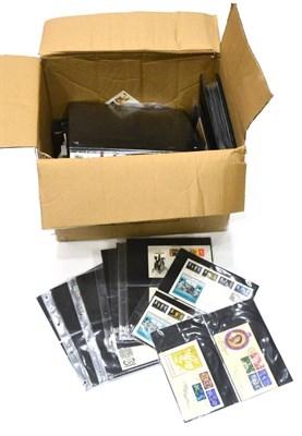 Lot 404 - Great Britain. A box containing hundreds of loose FDCs and commemorative covers. Two albums housing