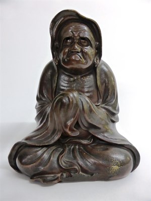 Lot 124 - A Japanese Glazed Terracotta Figure of an Ascetic, 19th century , modelled seated wearing...