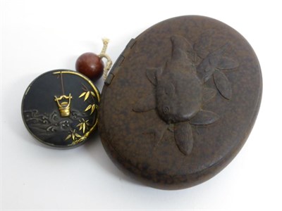 Lot 131 - A Gold Inlaid Iron and Karakuri Netsuke, Meiji period, of circular form decorated with a pail...