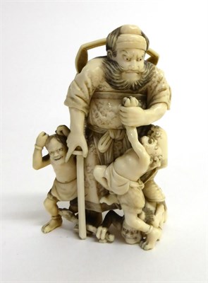 Lot 141 - A Japanese Ivory Okimono of Shoki, Meiji period, the demon queller standing holding his sword...