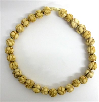 Lot 142 - A Japanese Ojime Bead Necklace, early 20th century, each bead carved as a group of rats, 50cm long