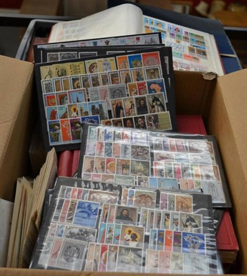 Lot 32 - A Plastic Container and a Box housing all world in albums and stockbooks. Includes stockbook of...